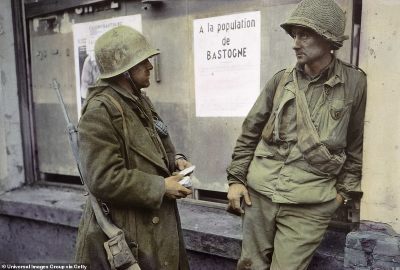 884-8176637-Soldiers_take_a_break_in_Bastogne_Belgium_One_leans_up_against_a-a-113_1585754910180.jpg