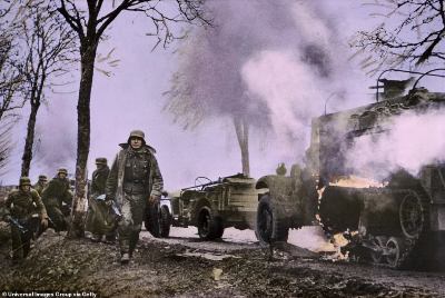 880-8176637-German_troops_walk_past_burning_U_S_vehicles_which_have_been_tak-a-114_1585754910248.jpg