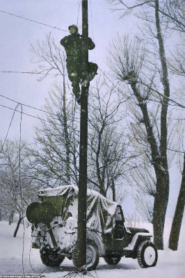 876-8176637-A_Signal_Corps_Lineman_repairs_damaged_telephone_lines_The_linem-a-119_1585754910361.jpg