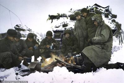 848-8176637-A_tank_crew_shares_a_campfire_to_keep_warm_as_they_eat_tehri_rat-a-124_1585754910533.jpg