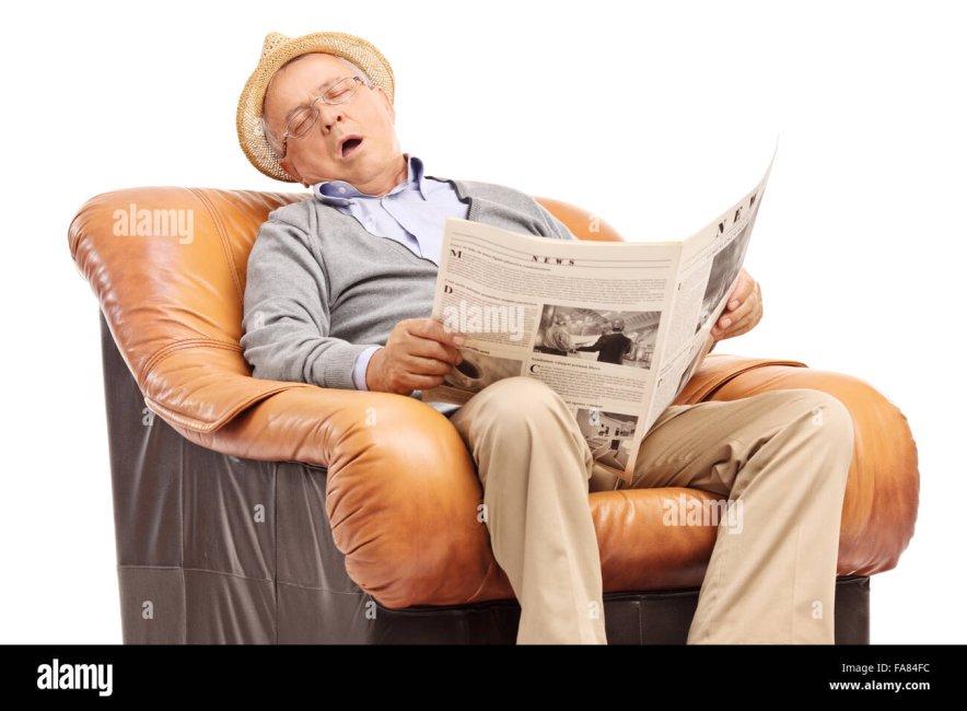 studio-shot-of-a-senior-man-sleeping-on-an-armchair-and-holding-a-FA84FC.jpg